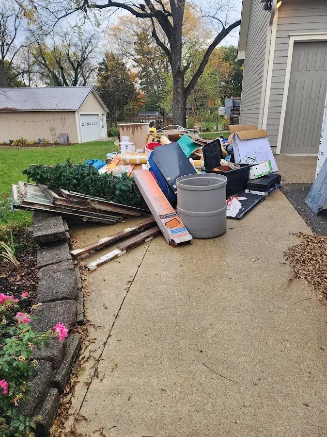 Dumpster being loaded with debris for Roofing Dumpster Rental in La Crescent